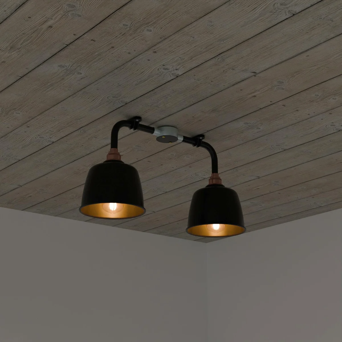 Black metal conduit ceiling light with two angled downlight fixtures and copper fittings in vintage industrial style