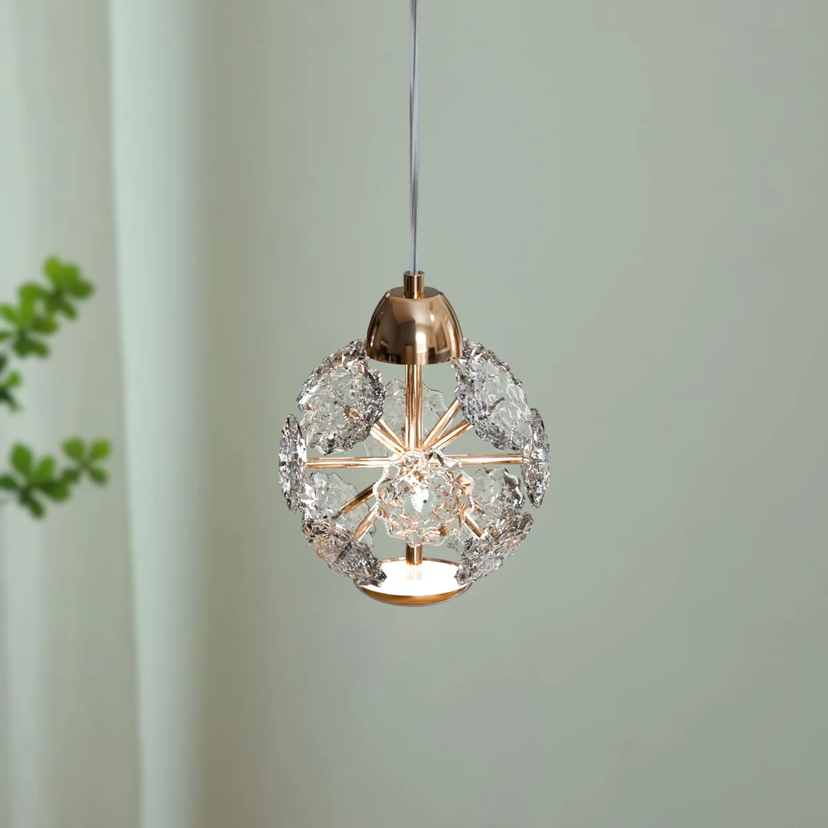 Modern pendant light with round amber textured crystal glass shade and adjustable metal cable hanging from ceiling