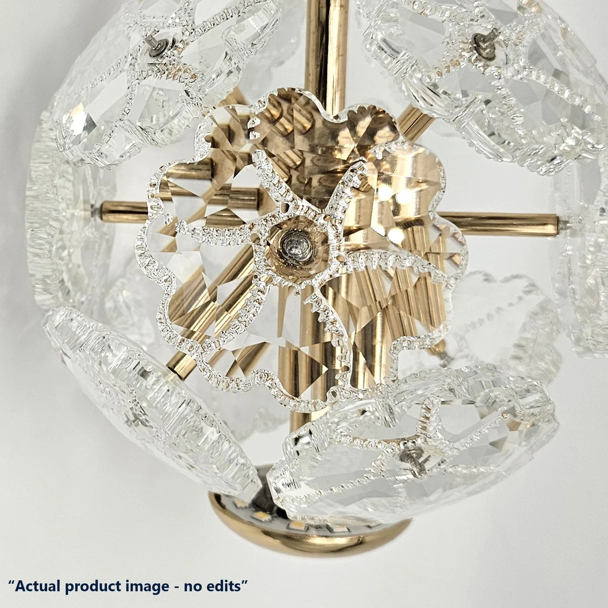 Modern pendant light with round amber textured crystal glass shade, adjustable cable, and metal fixture hanging from ceiling