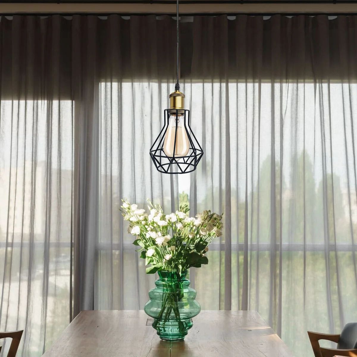 Three retro pendant ceiling lights with metal cage shades hanging from adjustable cables in a vintage style design