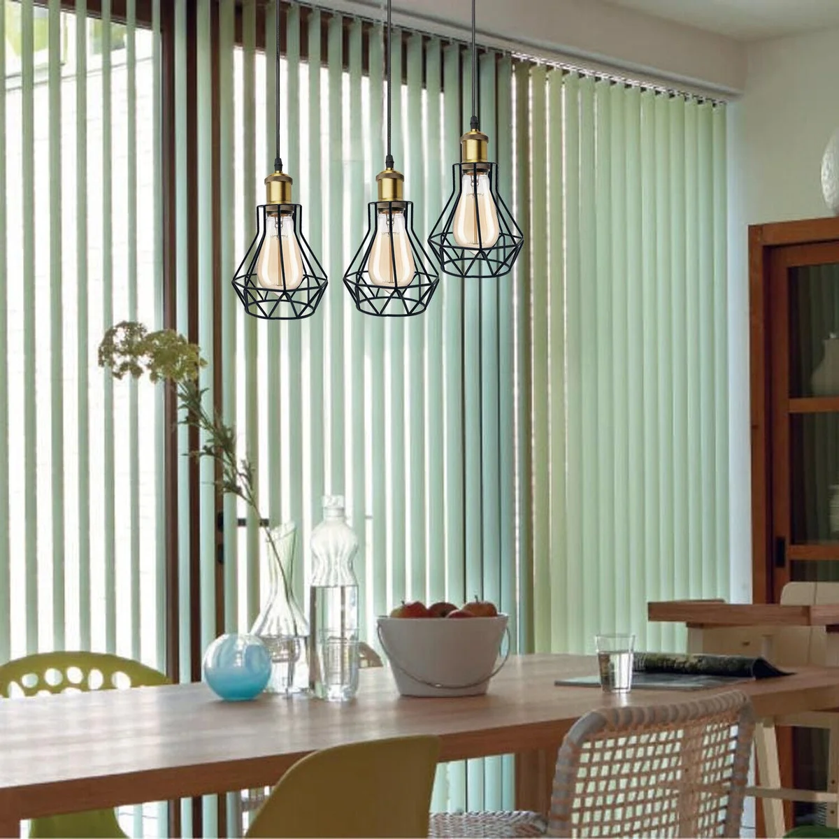 Vintage style 3 light pendant ceiling light with metal cage shades hanging from adjustable chain in warm ambient setting