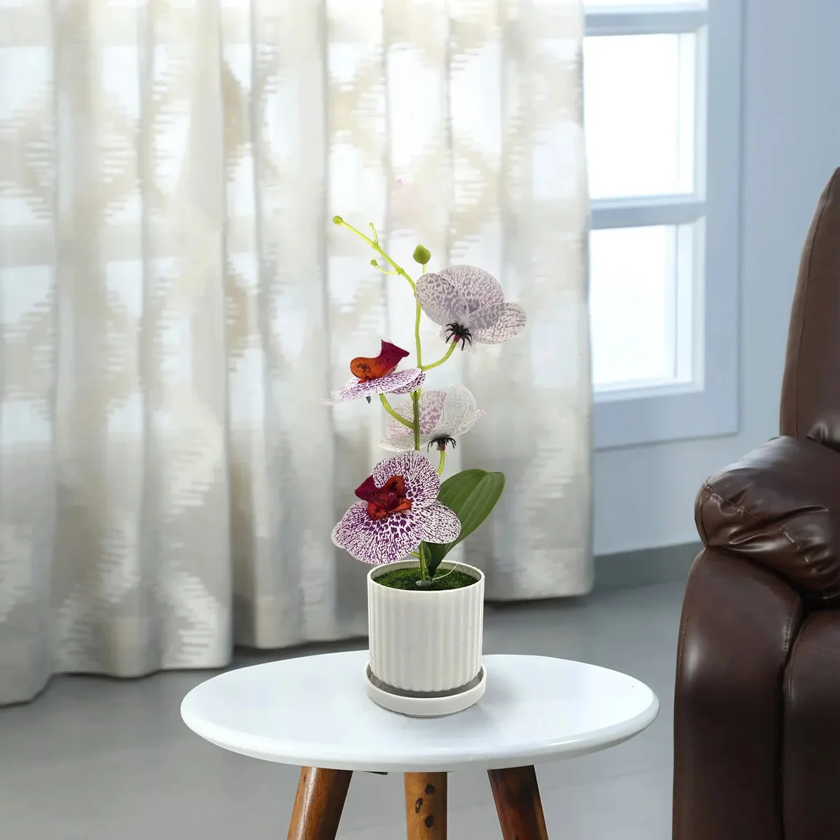 Artificial orchid plant with green leaves in a small modern pot, ideal for indoor table decoration, 30cm tall