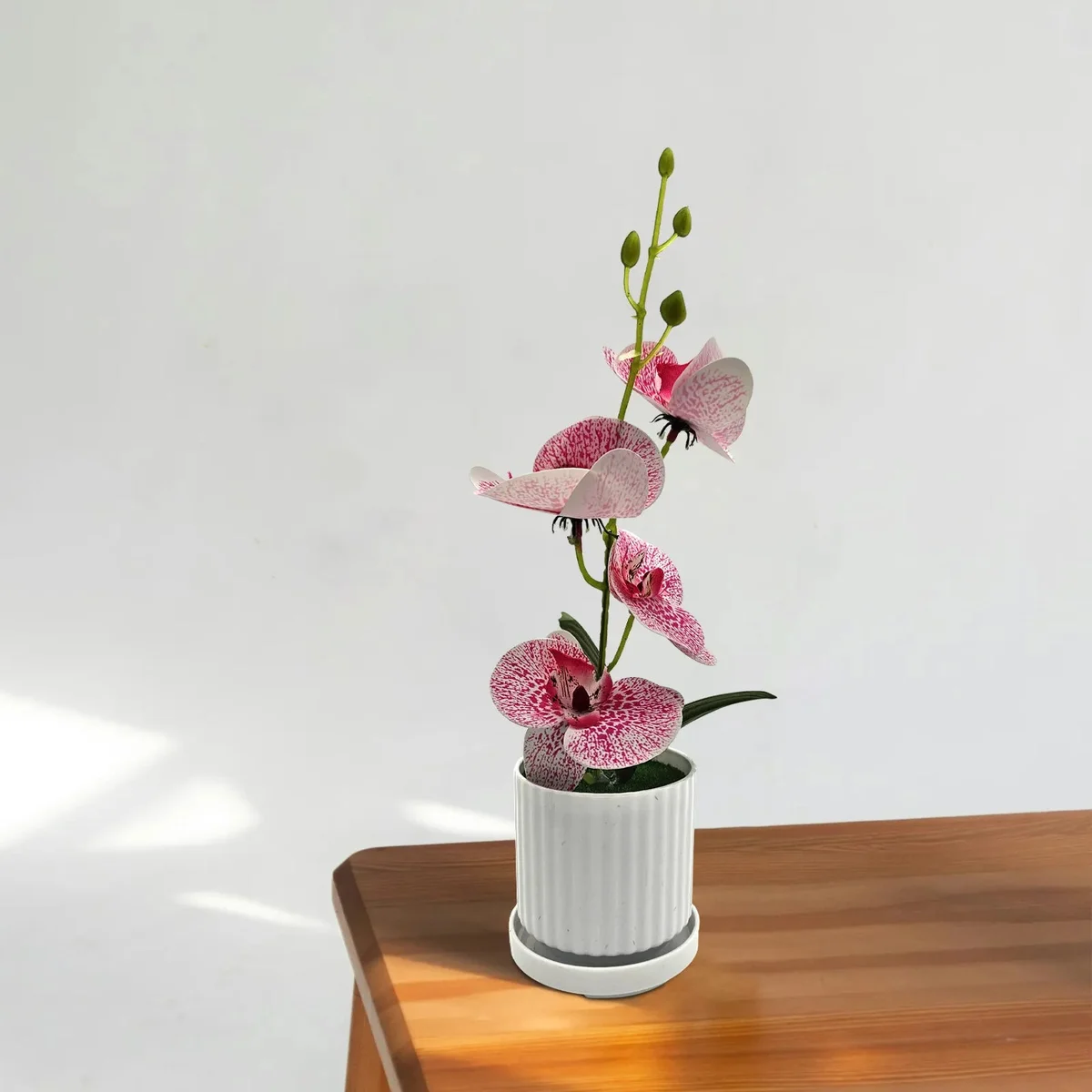 Artificial orchid plant with green leaves in a modern pot, ideal for indoor table decoration, 30cm tall silk flower display