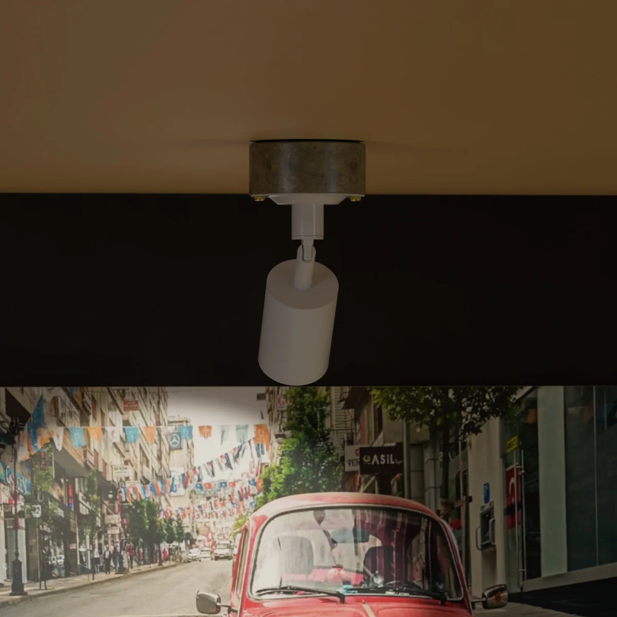 Rotatable wall spotlight in yellow brass with cylindrical metal design and attached galvanized steel conduit loop-in box