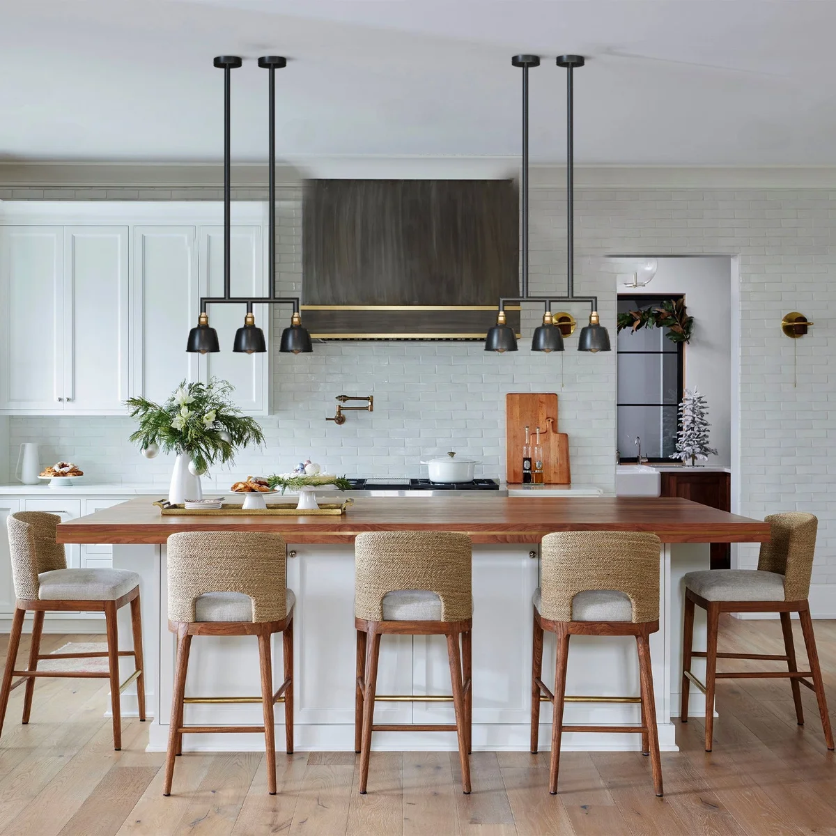 Three-light industrial pendant light with metal conduit pipes and dome shades, ceiling mounted for indoor use