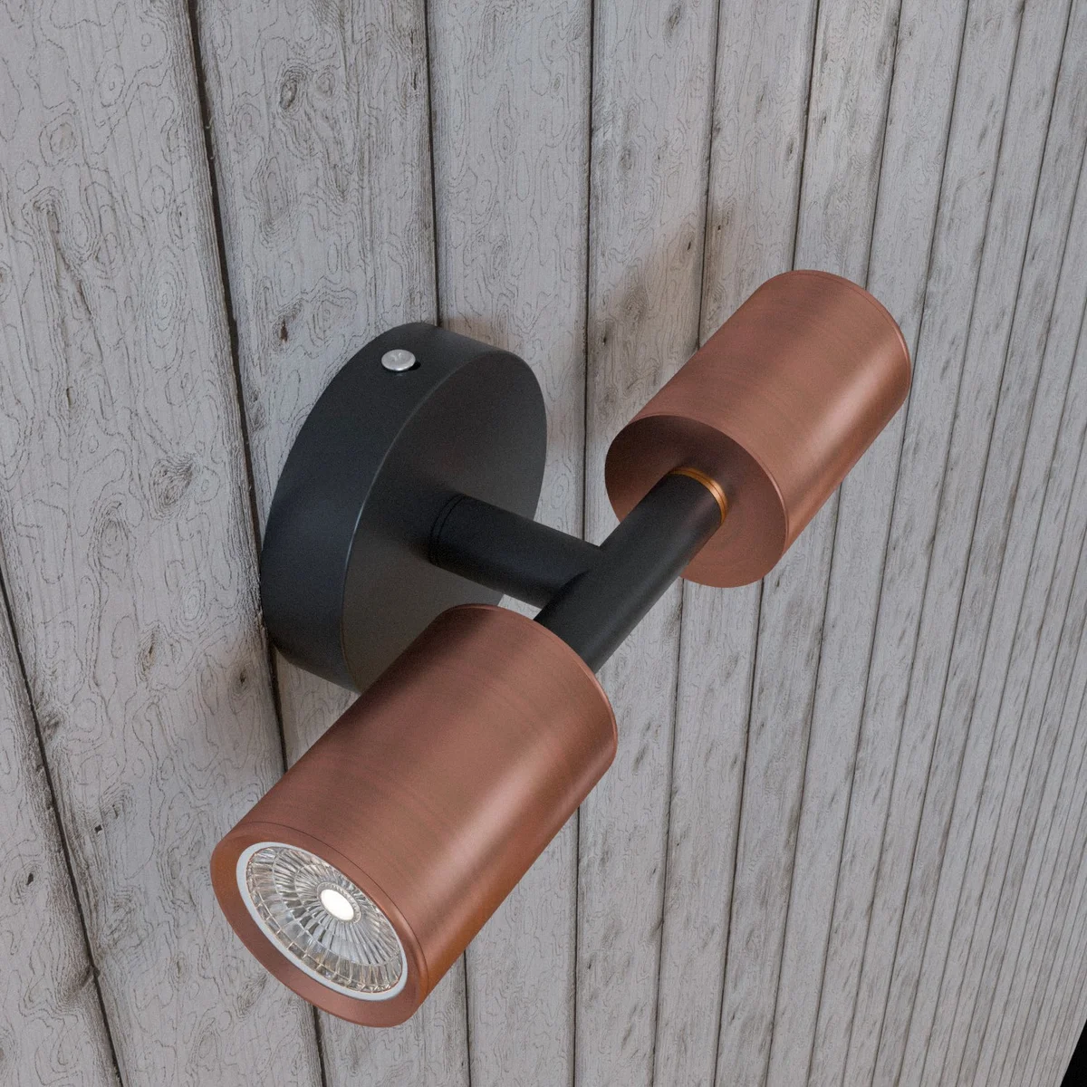 Modern double head wall light with two fixed cylindrical metal heads, designed for GU10 bulbs, mounted on white wall