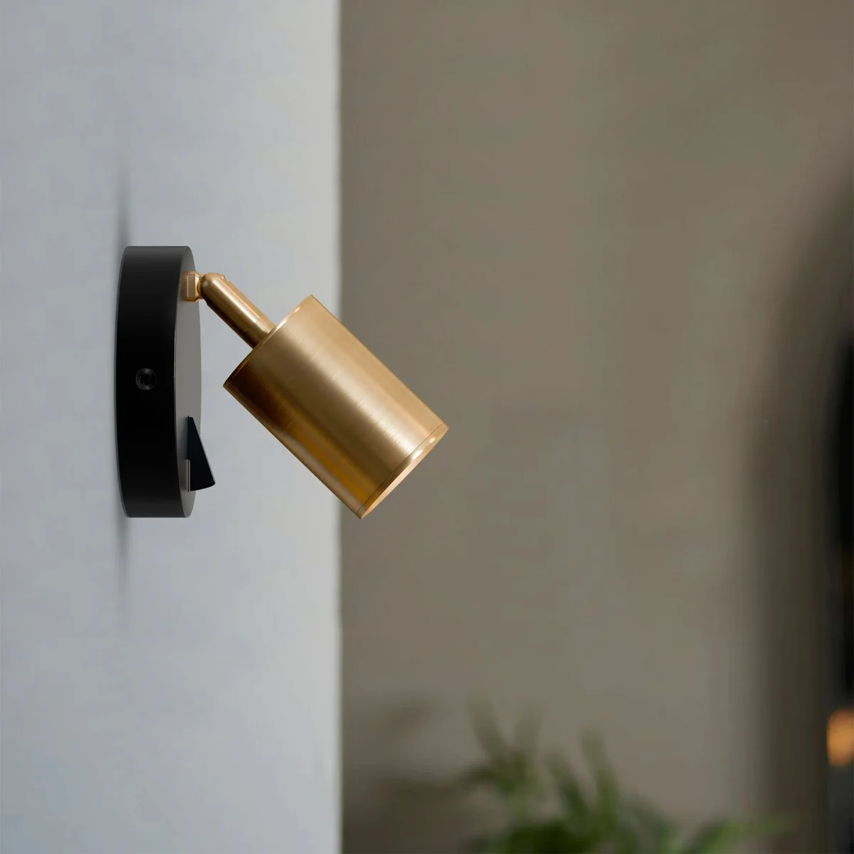 Rotatable yellow brass metal wall spotlight with cylindrical head and adjustable arm, featuring an on-off switch and GU10 bulb included