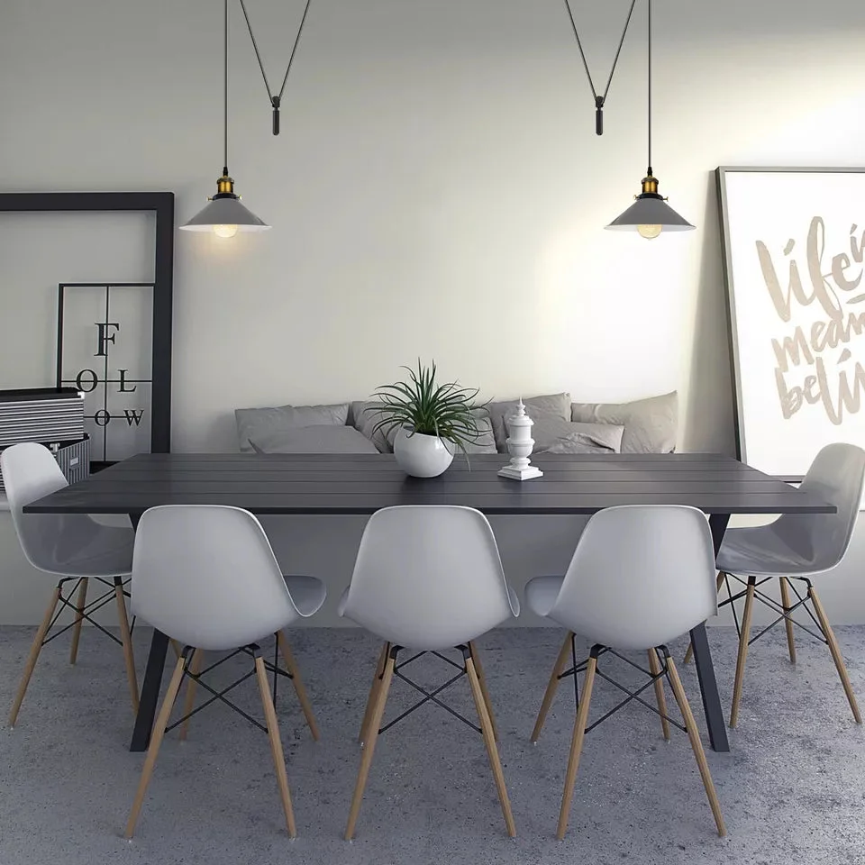 Vintage pendant light with metal cone shade and adjustable cord hanging from ceiling in industrial style design