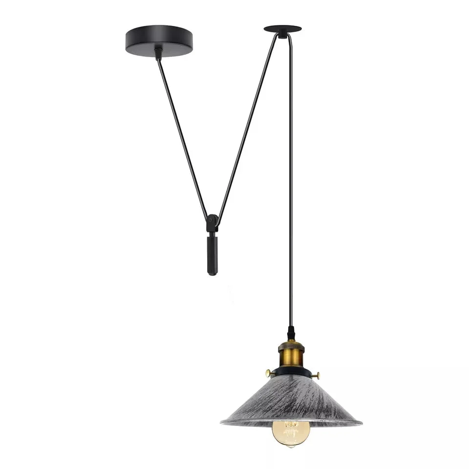 Adjustable vintage pendant light with metal cone shade and pulley system hanging from ceiling in industrial style room setting
