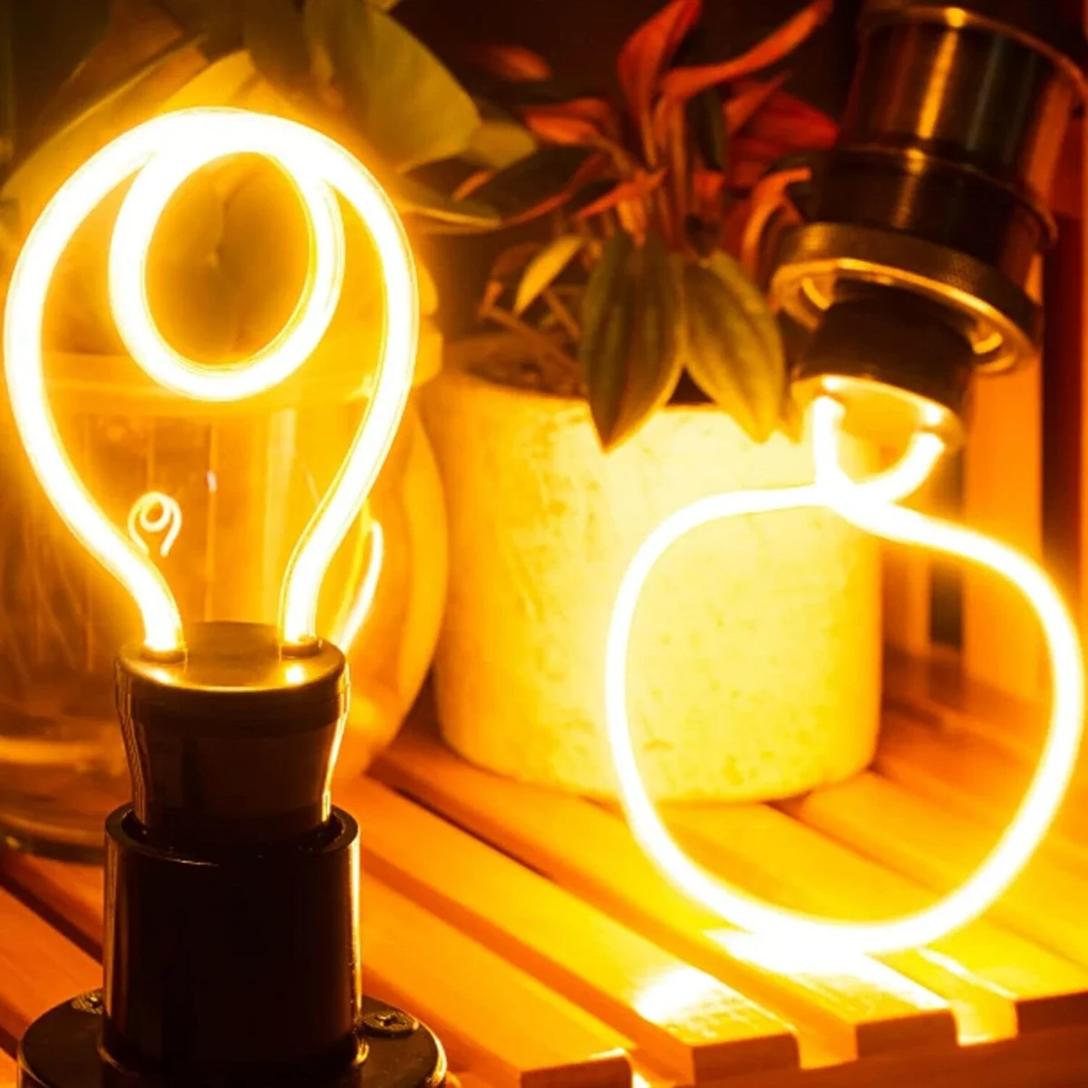 Vintage style polycarbonate LED bulb with neon filament glowing warm amber light on E27 fitting background