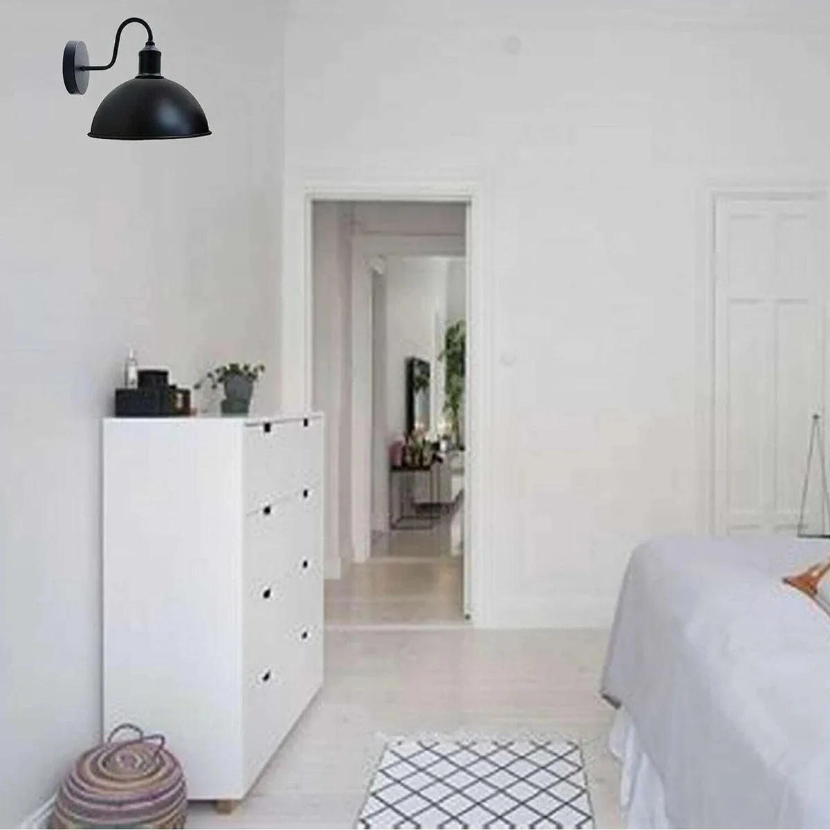 Black dome industrial wall sconce with curved metal shade and swan neck arm, suitable for indoor wall mounting