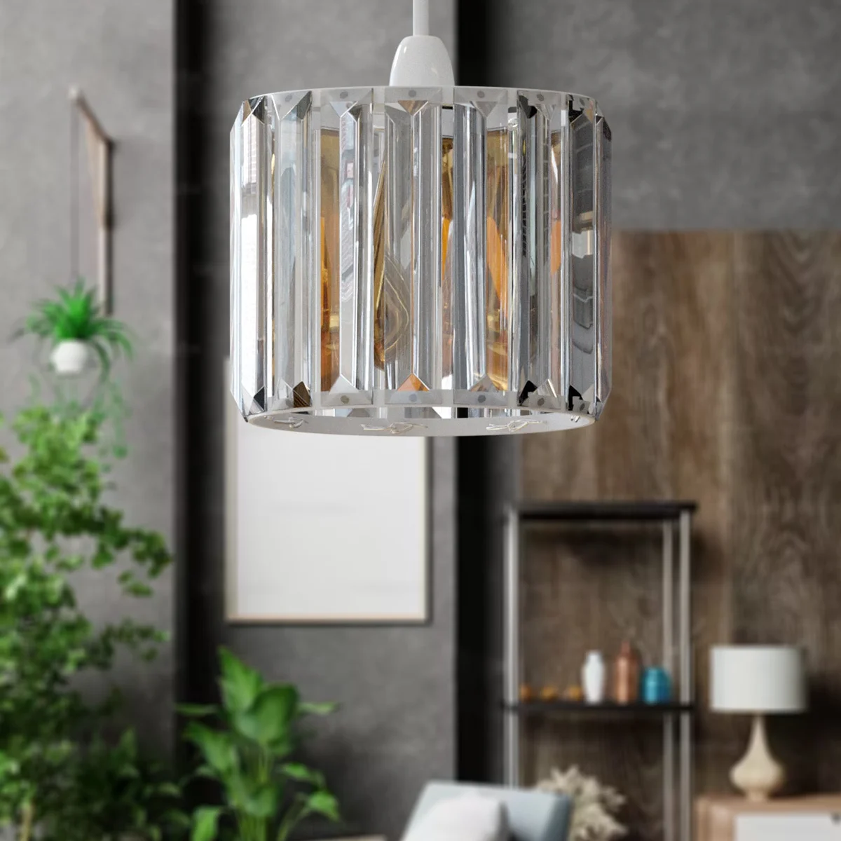 Modern crystal glass lamp shade with reflective chrome overlay perched on a slim reducer plate, showcasing a sleek drum shape.
