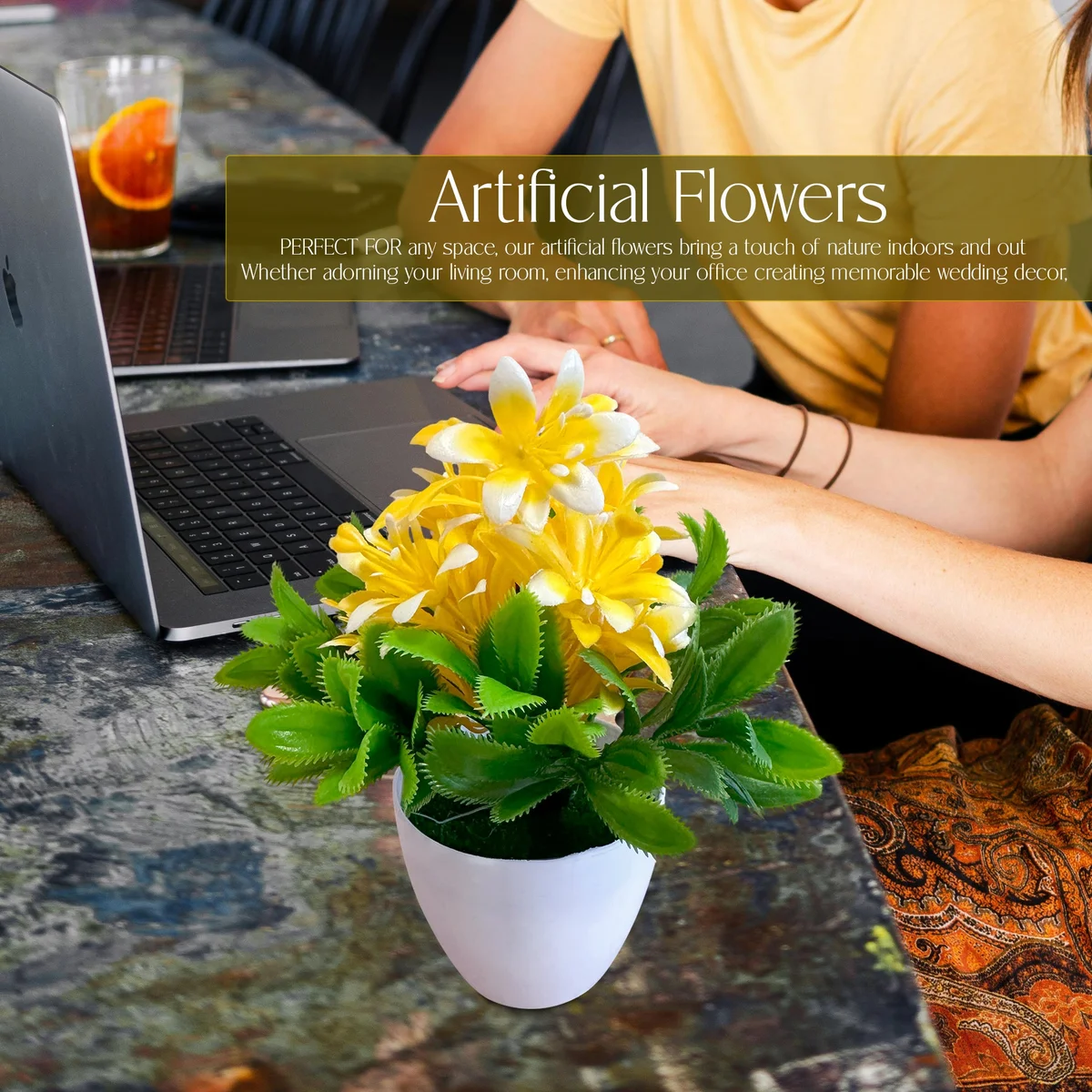 Small plastic pot with vibrant artificial flower plants featuring bright colours and lush green leaves indoors