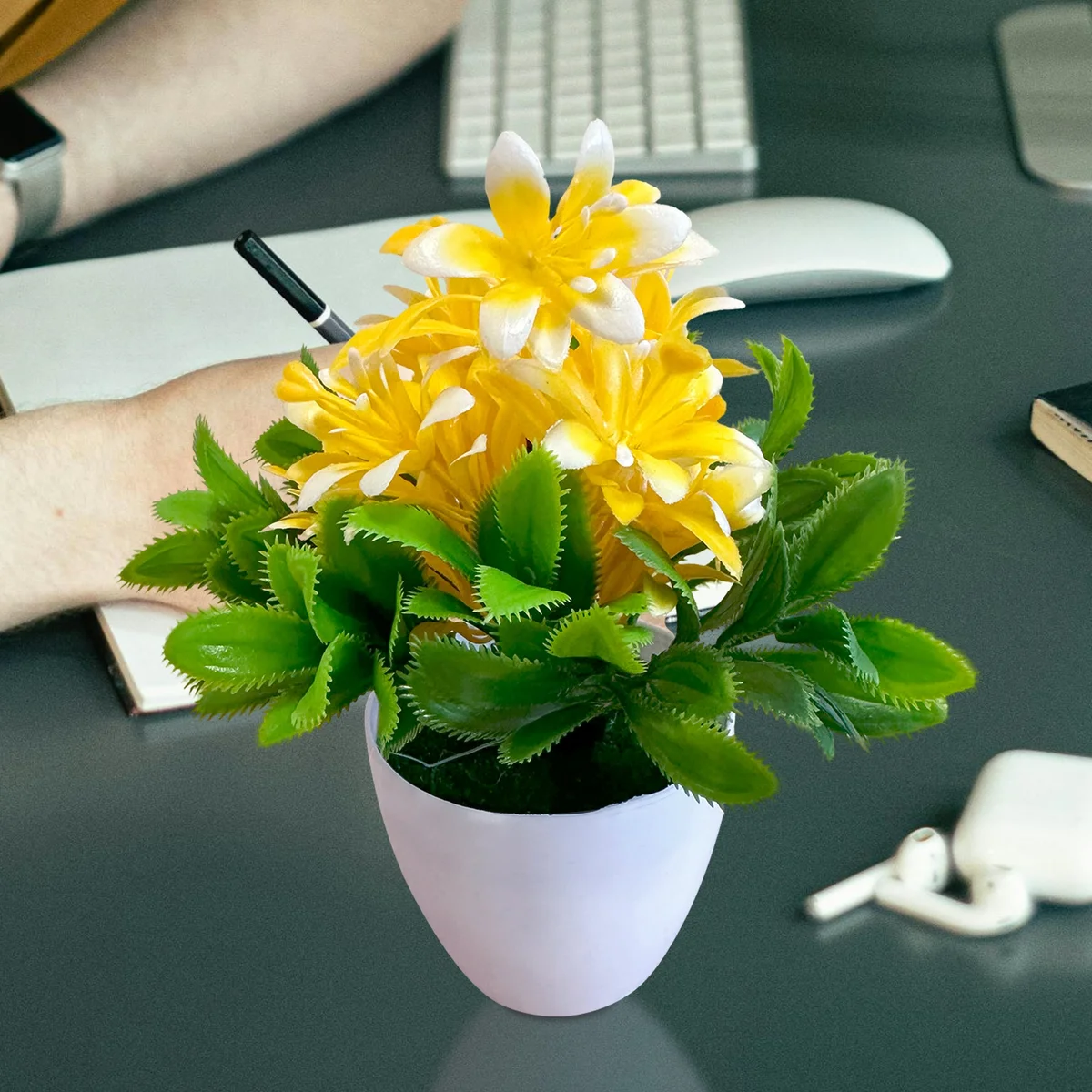 Bright artificial flower plants in small plastic pot with green leaves, ideal for indoor decor and low maintenance