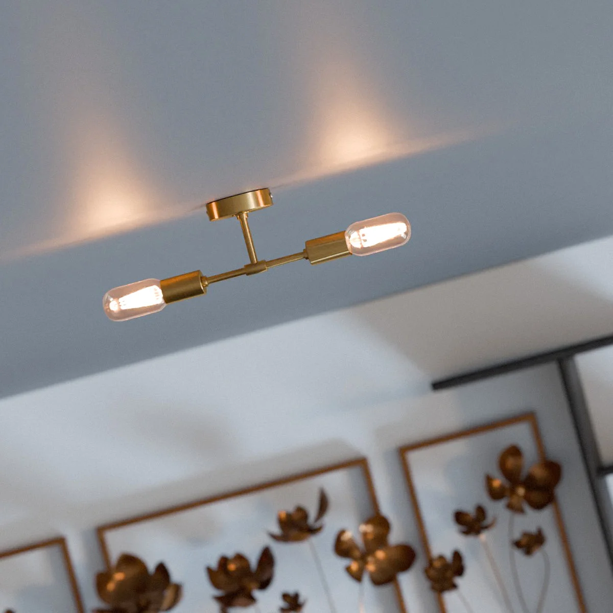 Dual socket metal wall ceiling light in polished rose gold finish with two E27 bulb holders mounted on a wall