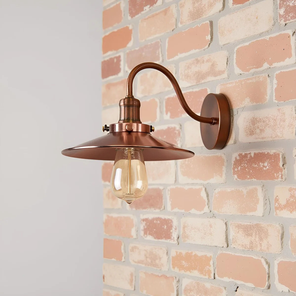 Black industrial wall light with flat metal shade and curved swan neck arm mounted on a 14cm ceiling rose