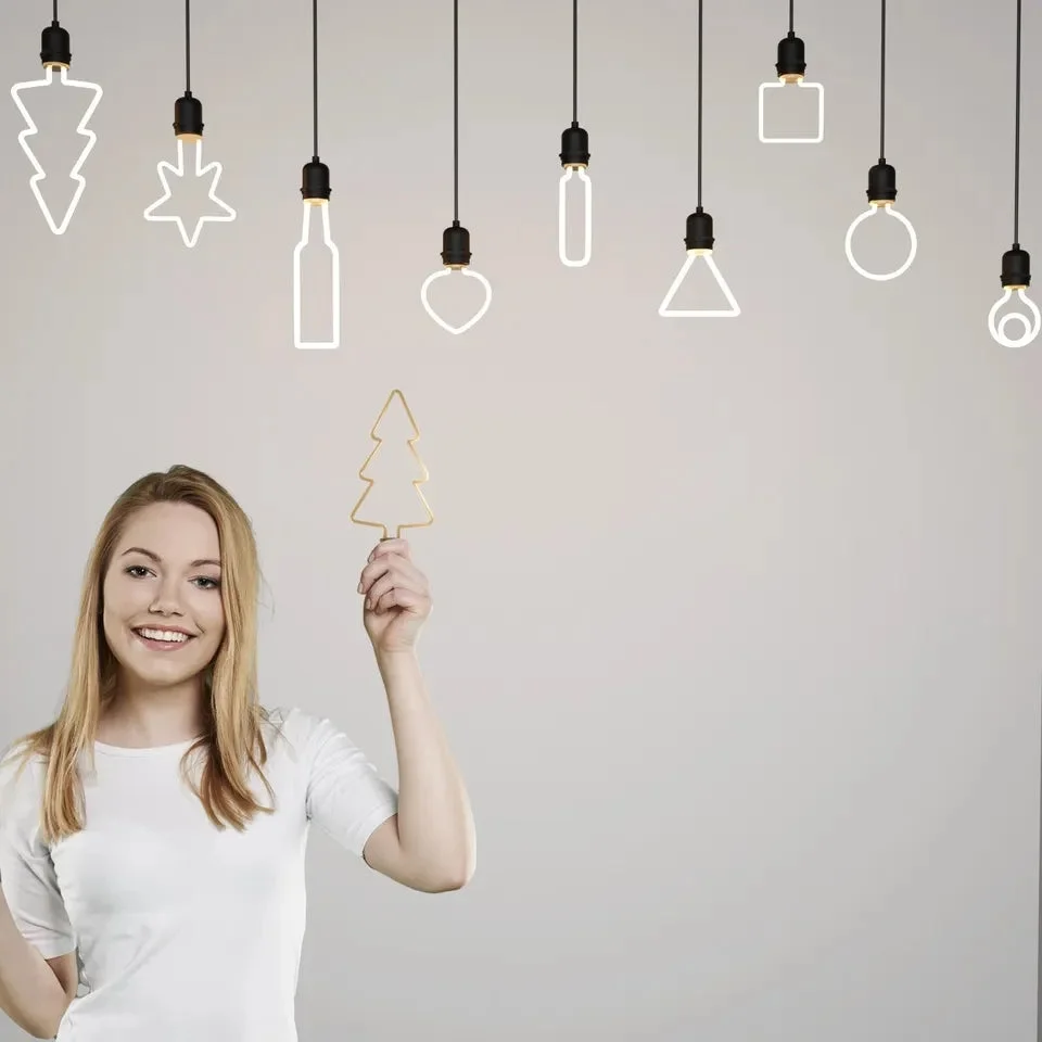 Set of warm white LED bulbs in festive shapes including stars, trees, hearts, and snowflakes with E27 base
