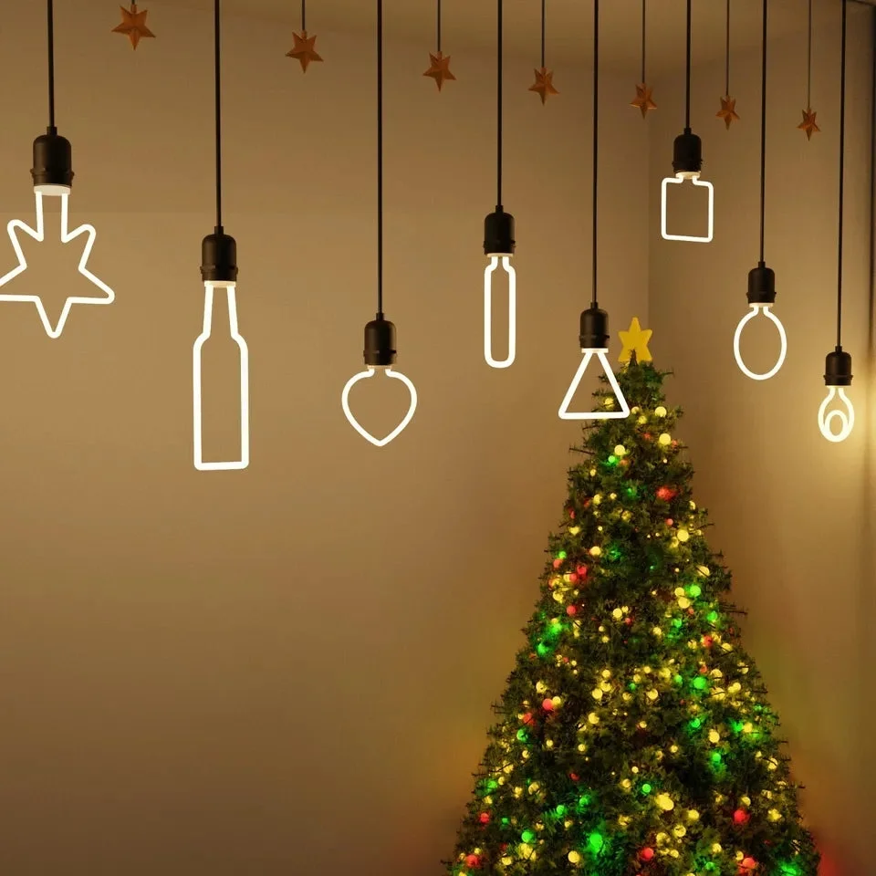 Set of warm white E27 Christmas lights with LED bulbs shaped like stars, trees, hearts, and snowflakes on a dark background