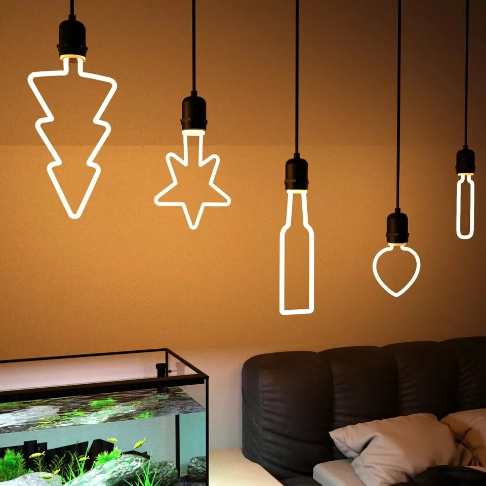 Dimmable LED bulbs shaped as stars, hearts, trees, and snowflakes glowing warm white with E27 base