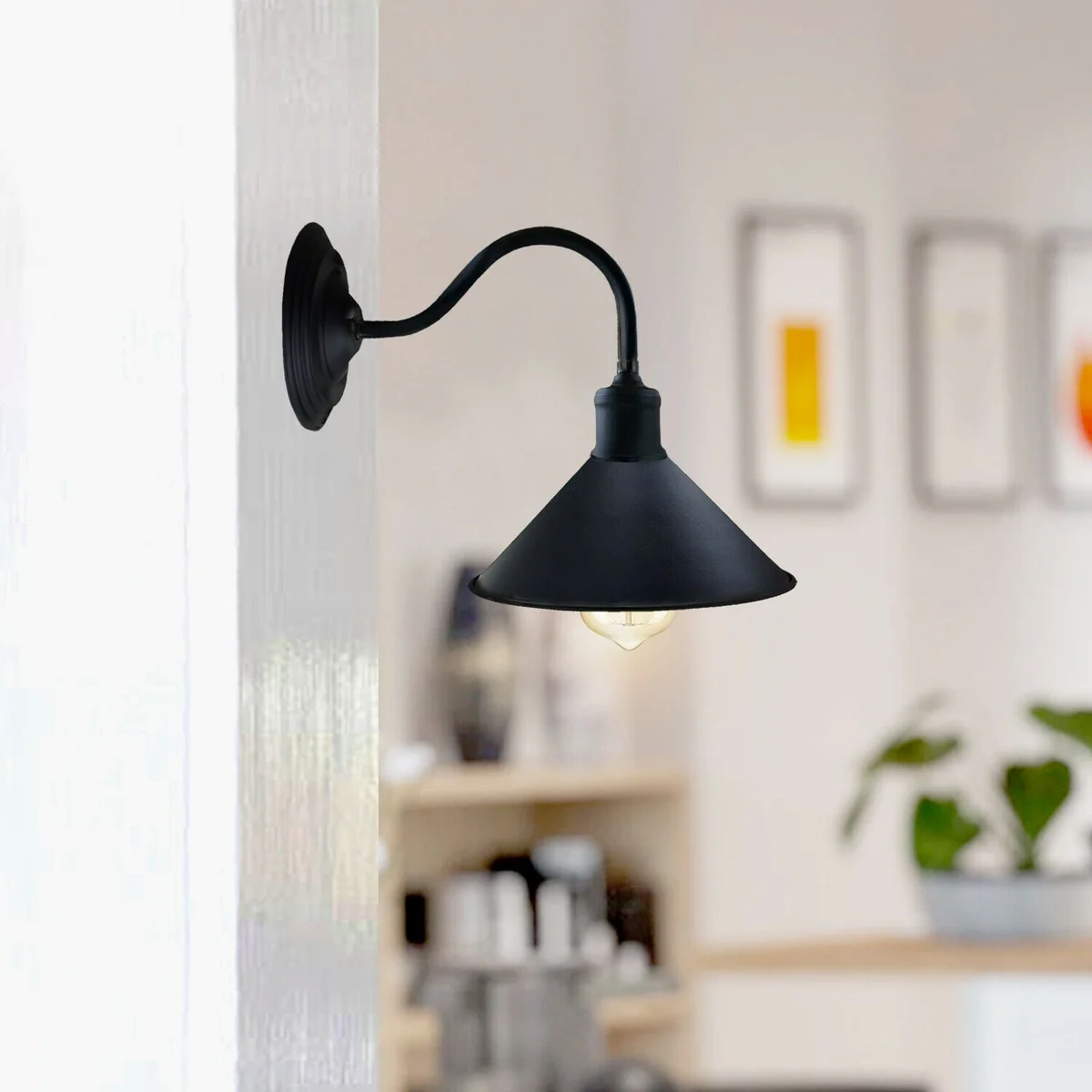 Industrial metal cone wall lamp with 22cm conical shade and curved arm in matte black finish mounted on white wall