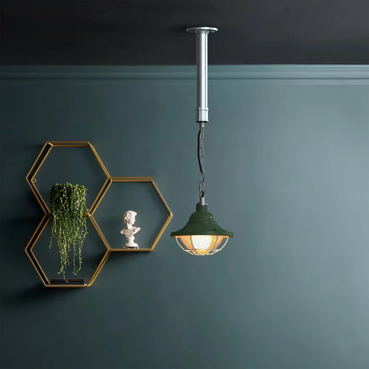 Industrial pendant light with polished metal wire cage and pipe-style frame designed for 3/4 inch conduit installation