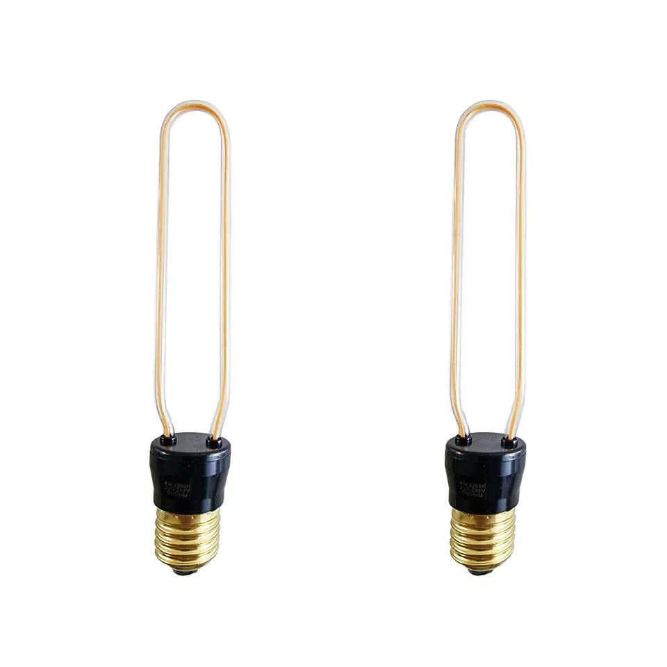 Decorative Edison bulb with flexible LED filament and warm yellow glow in E27 screw fitting on clear glass background