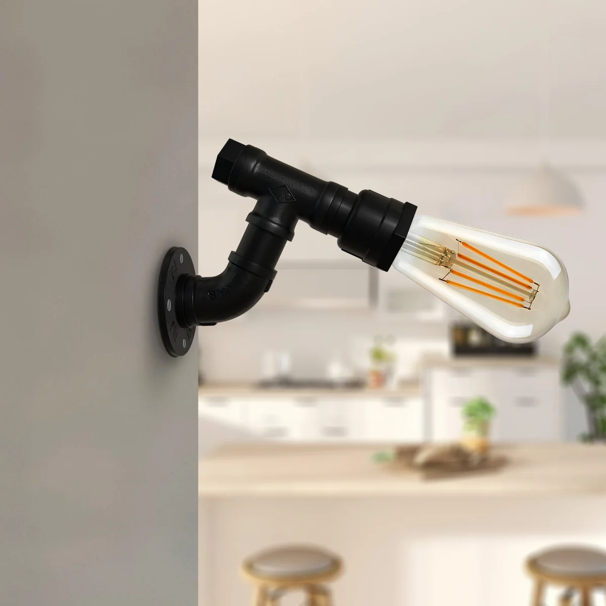 Vintage industrial wall light with black metal steampunk water pipe design mounted on a white wall indoors