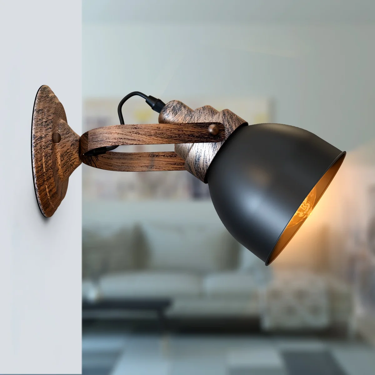 Matt black bell shaped wall lamp with wood-effect finish and metal shade mounted on a white wall with wiring visible