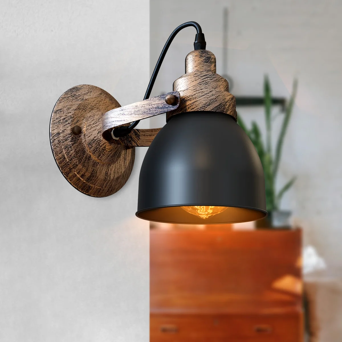 Industrial wall light with wood-effect bell shade and matt black metal, mounted on a wall with visible hardware kit parts