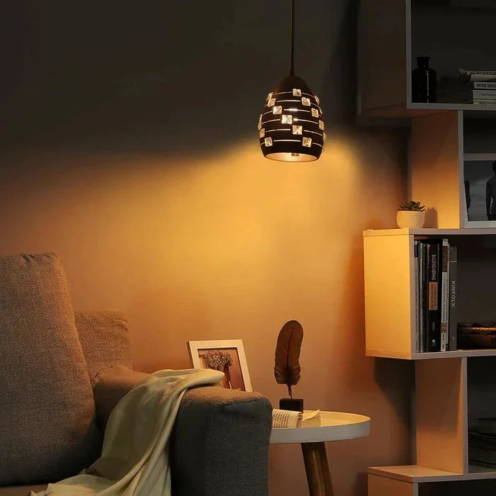 Modern crystal pendant light with matte black metal finish and adjustable wire pendant lamp hanging from ceiling