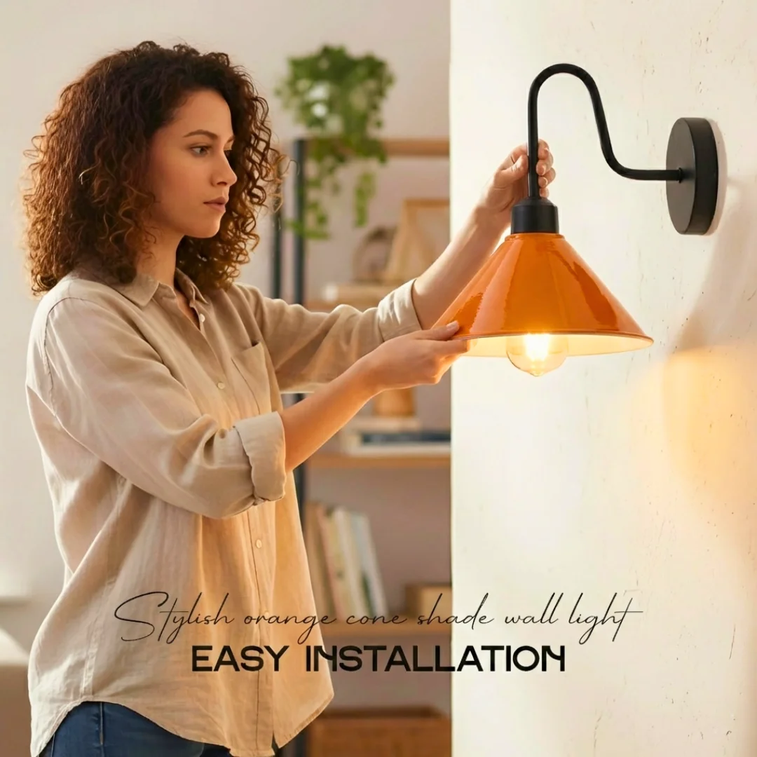 Orange metal cone wall light with black swan neck arm, ideal dimmable indoor lighting for vintage style spaces