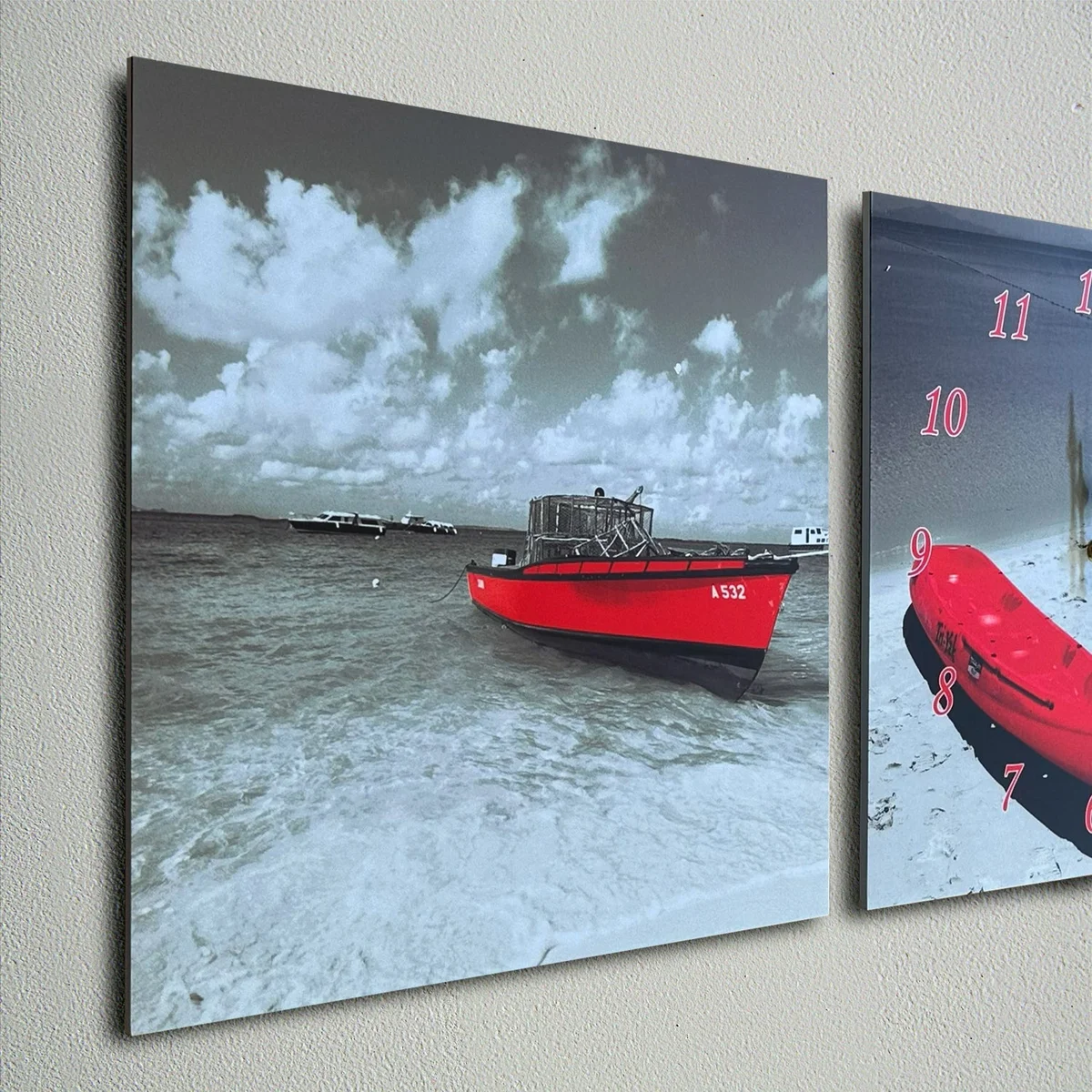 Red boat wall clock with three-frame design, sleek red finish, and 3D figure, hanging on a white wall indoors