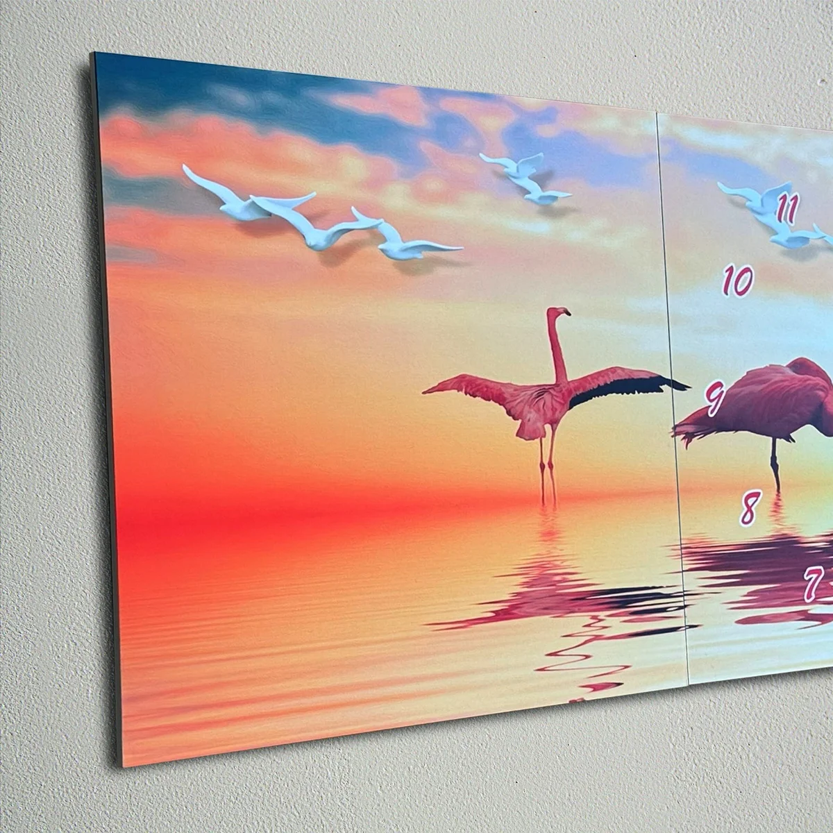 Three-panel flamingo canvas wall clock with tropical leaves, sleek design, and quiet battery clock mechanism on display