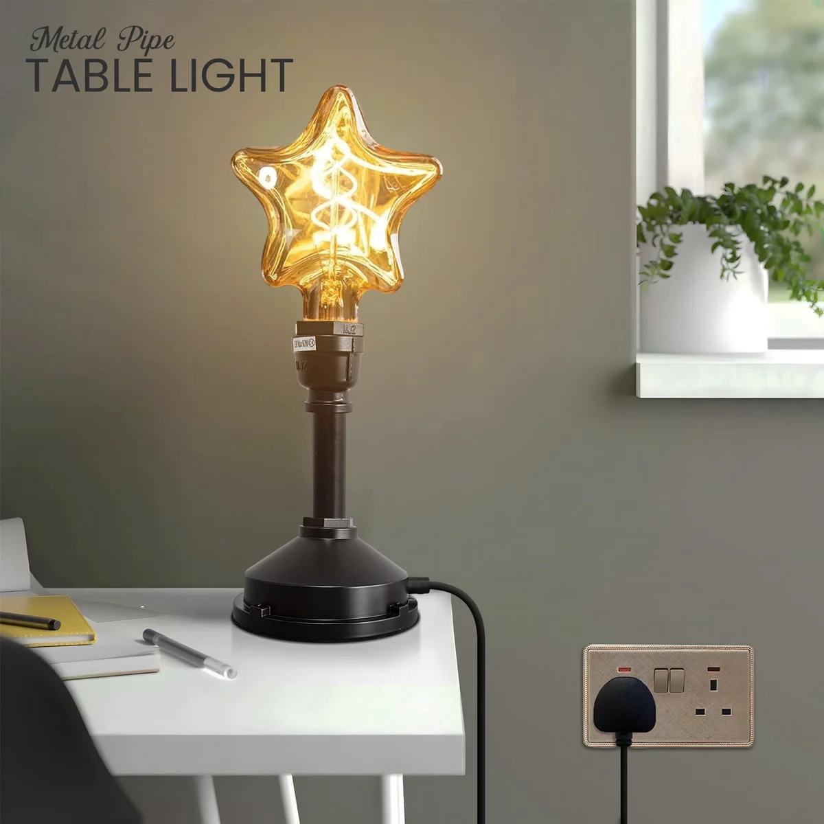 Steampunk table lamp with black metal water pipe design, inline switch, and E27 bulb on wooden surface background