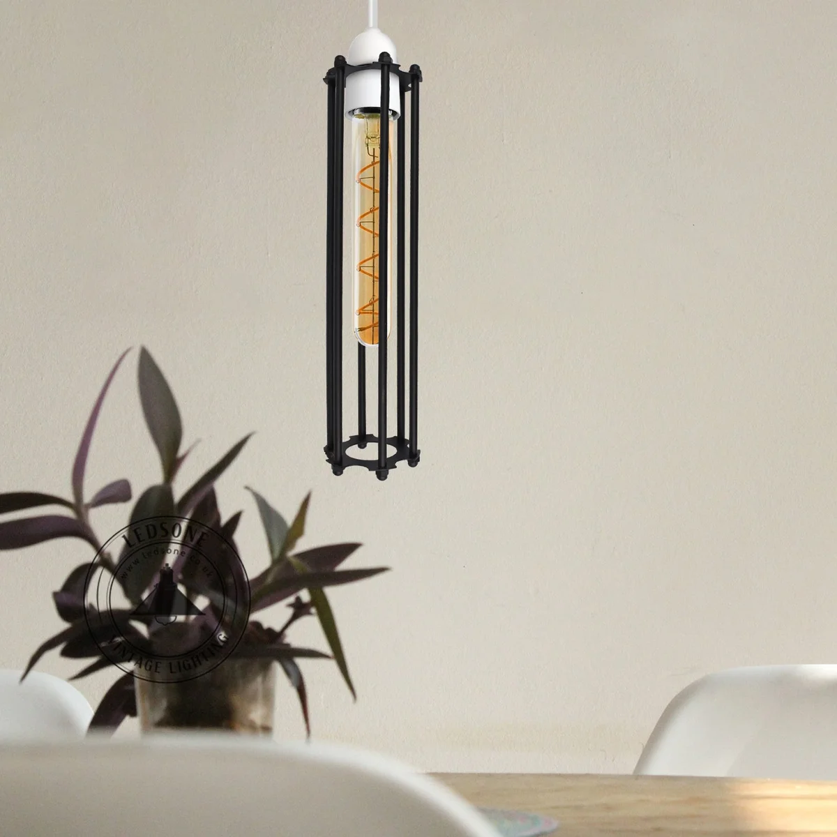 Brushed brass vintage long metal wire cage industrial pendant light with cylindrical open frame design hanging from ceiling