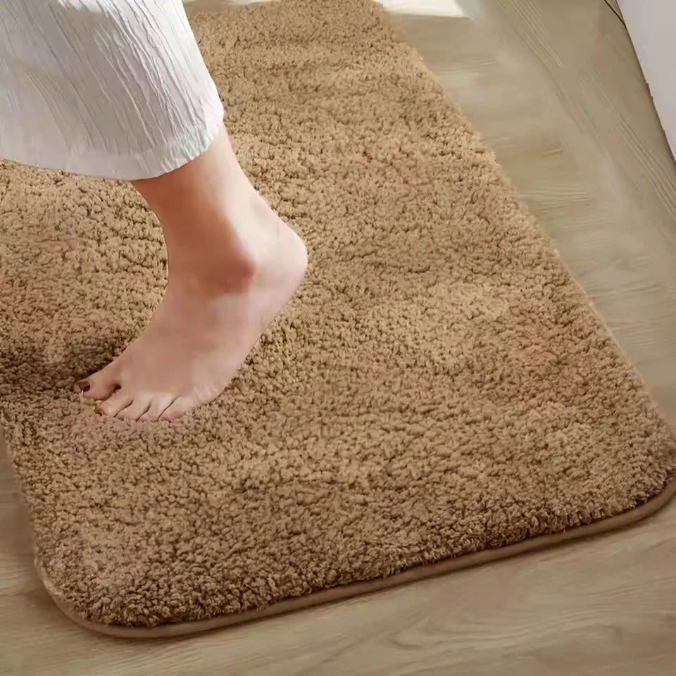 Rectangular ultra-soft microfiber anti-slip doormat in neutral color with plush texture on wooden floor indoors