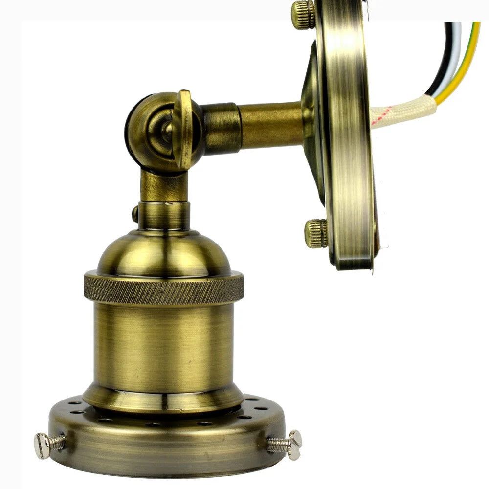 Industrial wall sconce with aged steel finish and E27 bulb base mounted on a black metal wall plate
