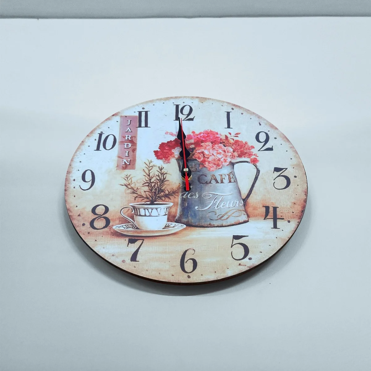 Round cafe cup wall clock with floral shabby chic design, large numbers, and battery-operated ticking mechanism on MDF material