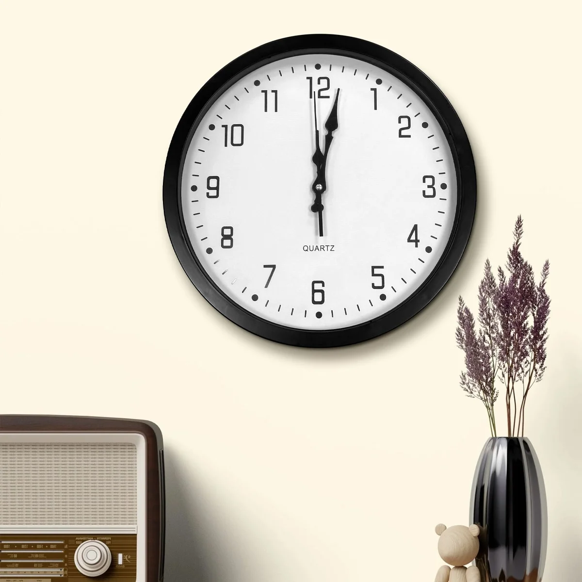 Modern round analog wall clock with black plastic frame and large white numbers on black face, 35cm diameter