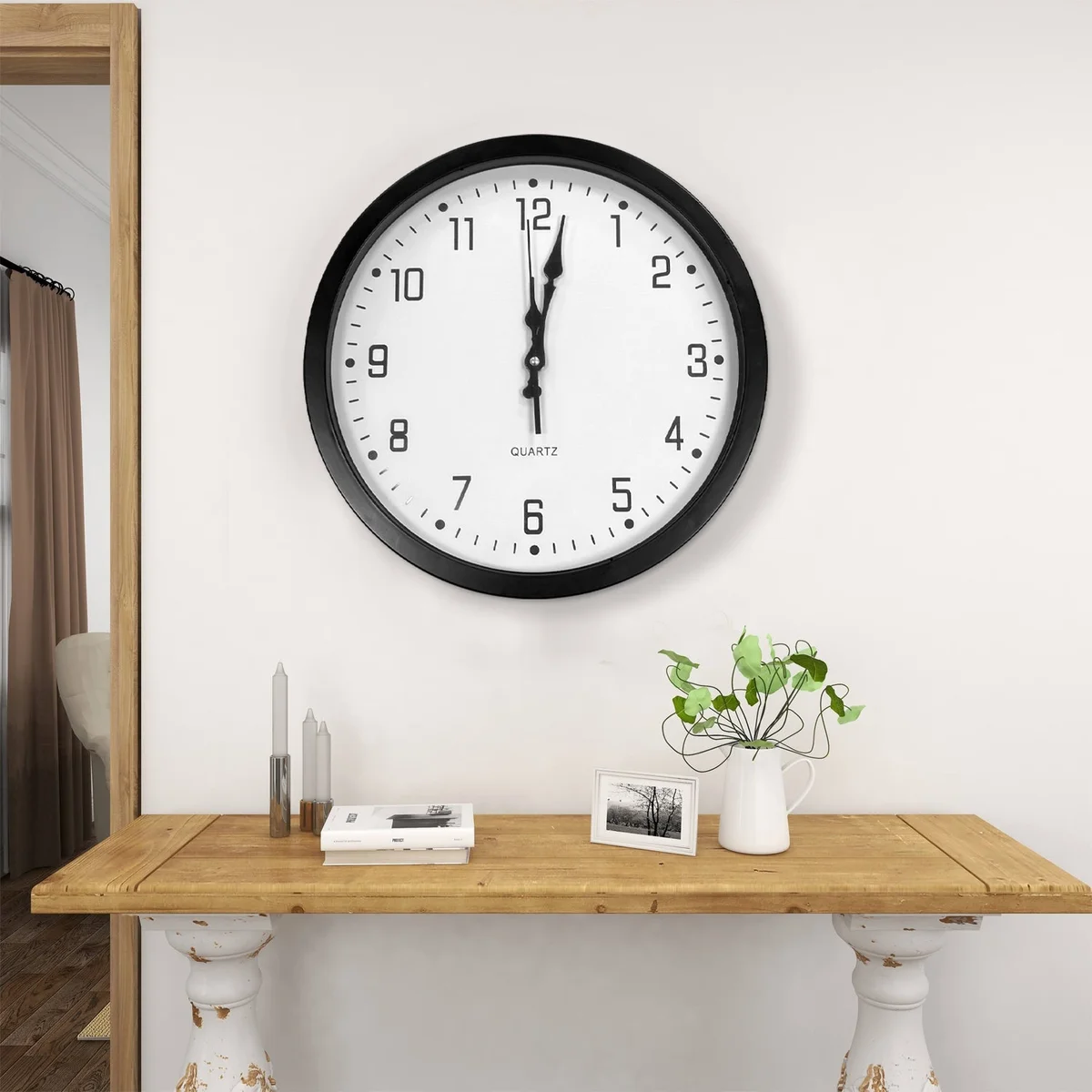 Modern wall clock with black plastic round frame, large white analog numbers on black face, 35cm diameter.