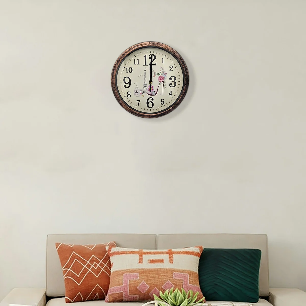 Round shabby chic wall clock with distressed patchwork wooden frame and vintage analog hands on white background