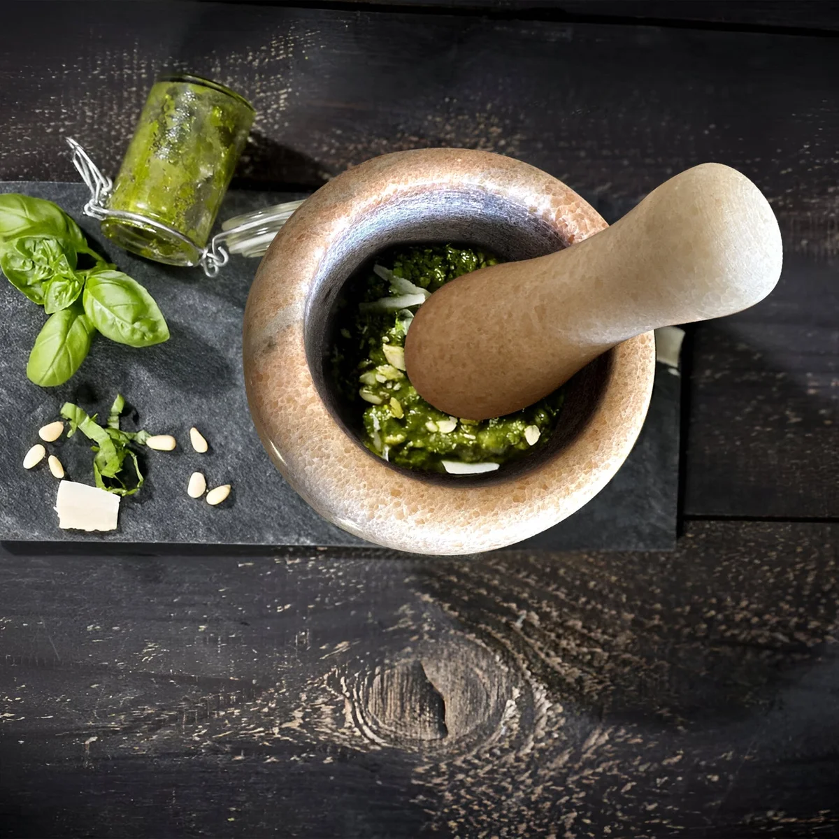 Polished marble mortar and pestle set with pestle resting inside, ideal for grinding herbs and spices in kitchen use