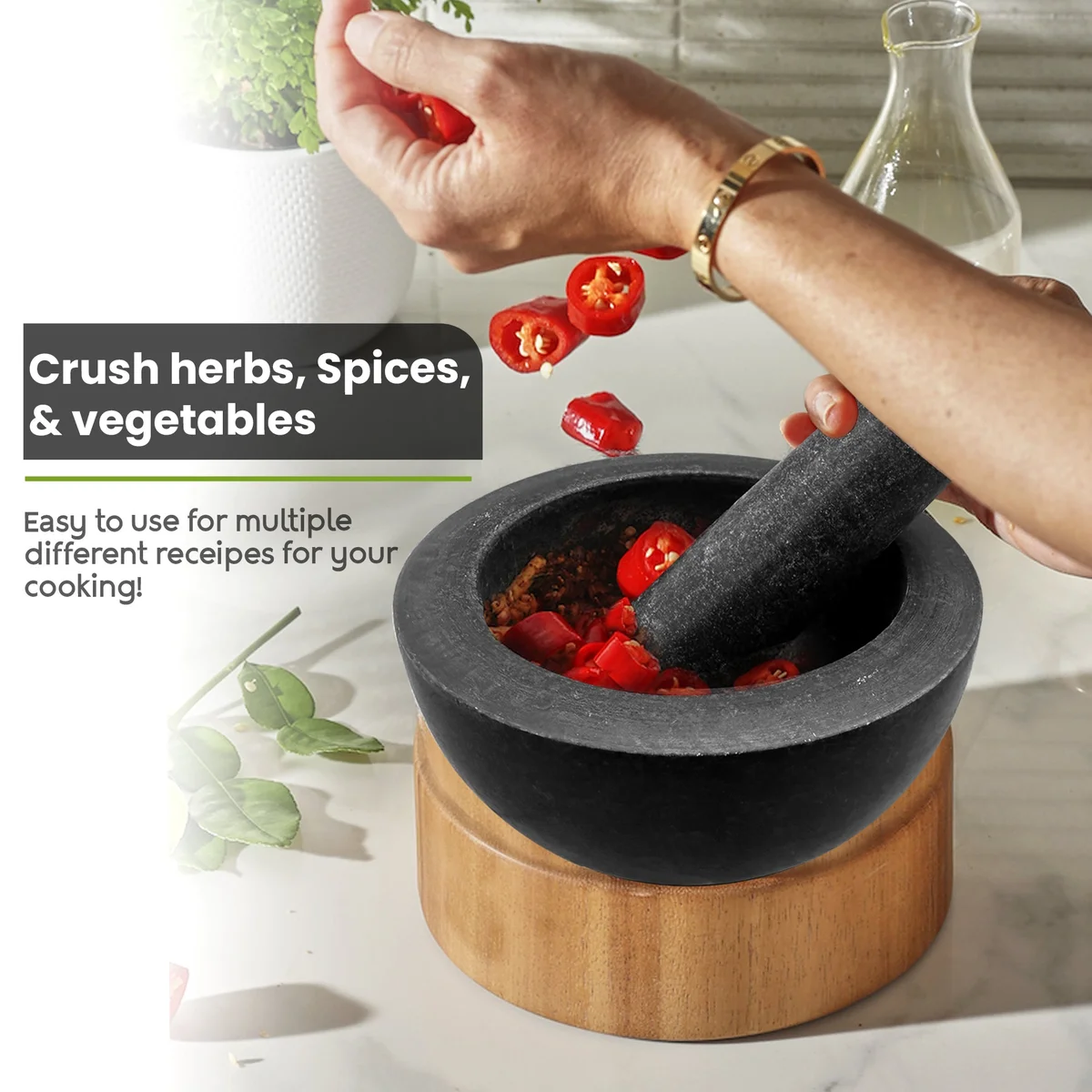 Black granite mortar and pestle set with polished finish, ideal for grinding spices, herbs, and nuts in the kitchen