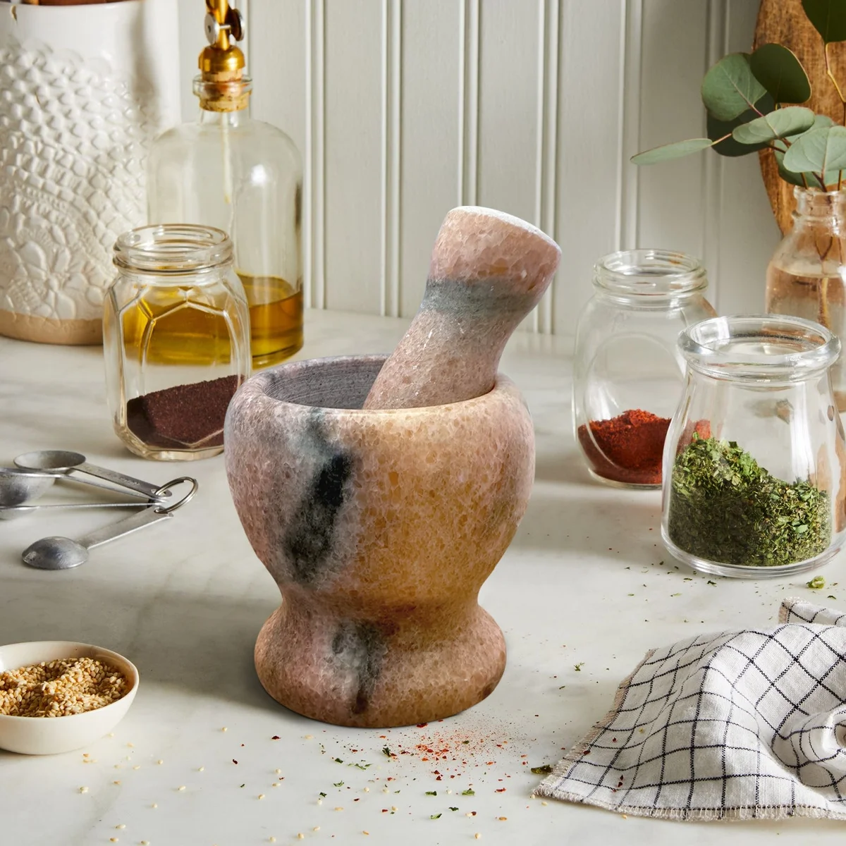Polished marble pestle and mortar set, 11cm tall, includes sturdy handle and bowl.