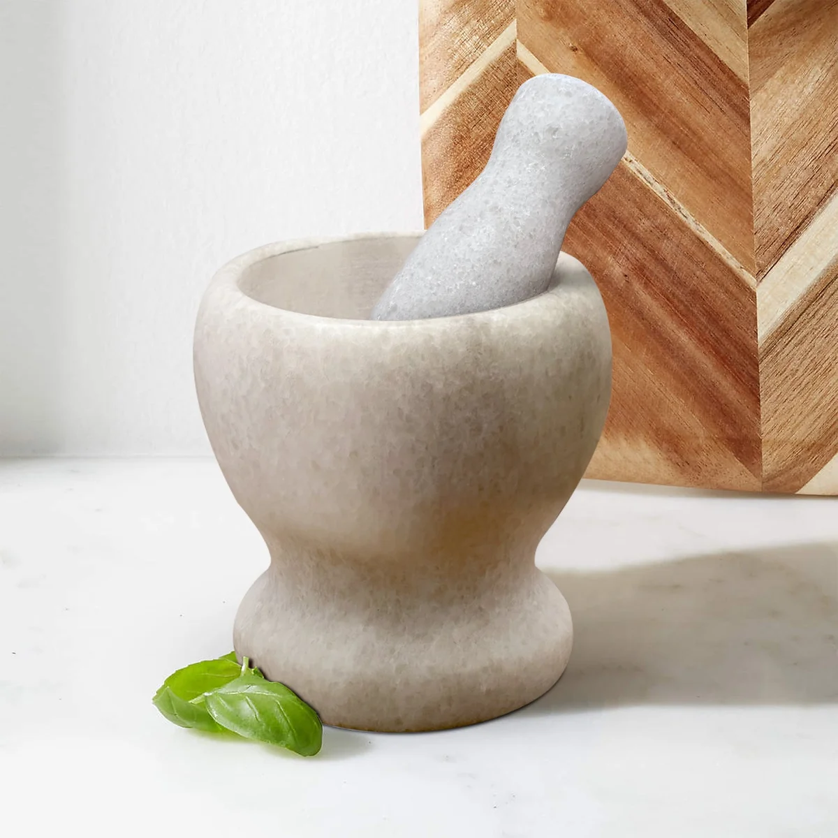 Polished marble herb crusher grinder with easy‑grip handle, 11 cm height and width, ready for cooking.