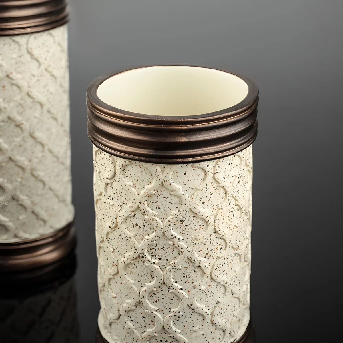 Set of three modern bathroom accessories including lotion dispenser, toothbrush holder, and tumbler with stone effect design