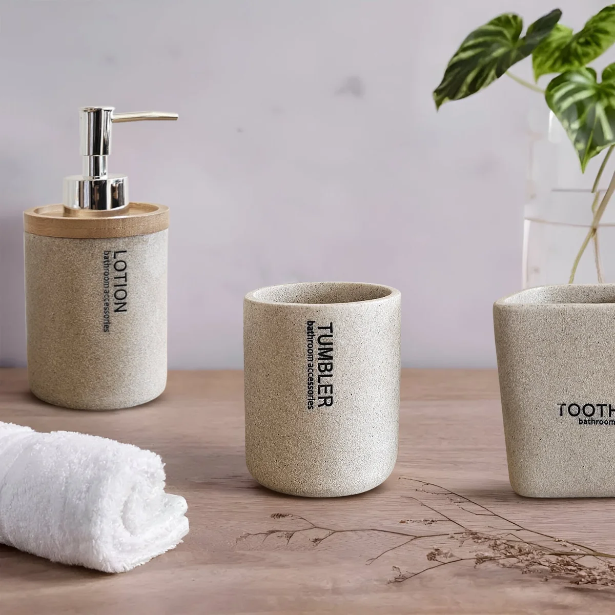 Modern luxury stone effect bathroom set with resin lotion dispenser, toothbrush holder, and tumbler in neutral tones