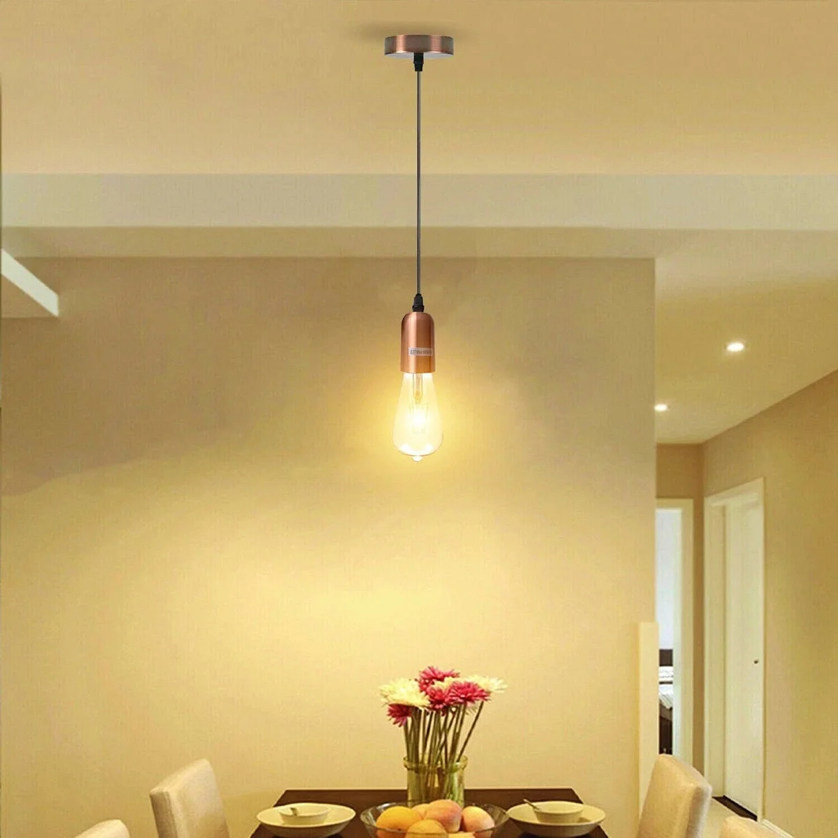 Adjustable pendant light with metal E27 bulb holder and black PVC cable hanging against white background