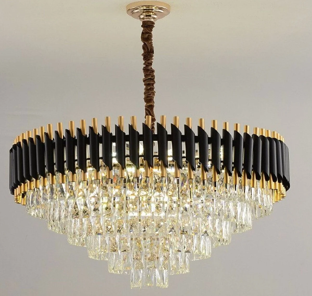 Modern crystal chandelier with black and gold metal frame, crystal lampshade, and matching wall lights in a classic modern style