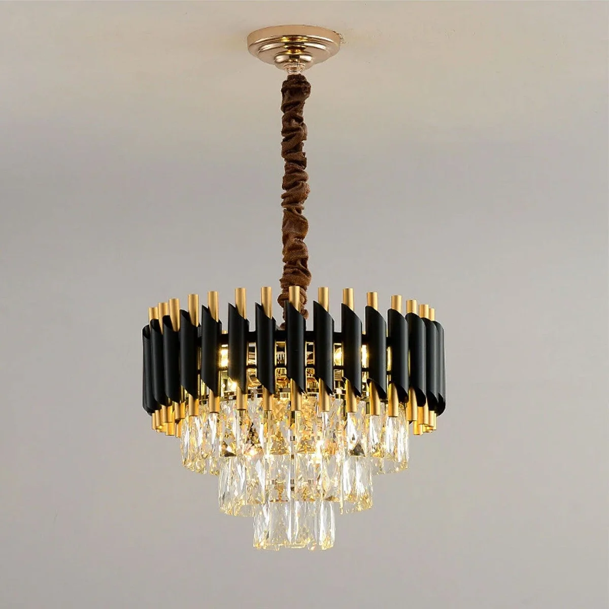 Modern crystal chandelier with black and gold metal frame, round design, and matching wall lights for elegant home décor